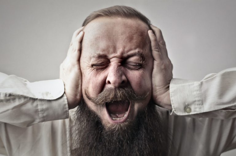 close-up-photo-of-screaming-man-with-a-full-beard-covering-3764535-scaled